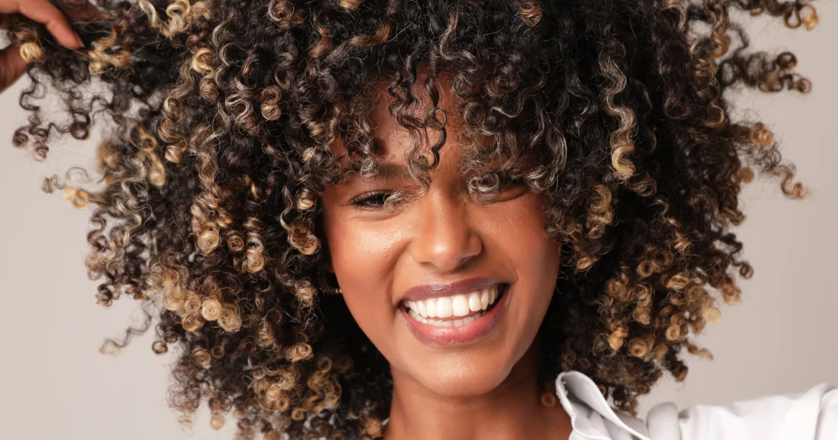 Model showing off her vivid curly hair.
